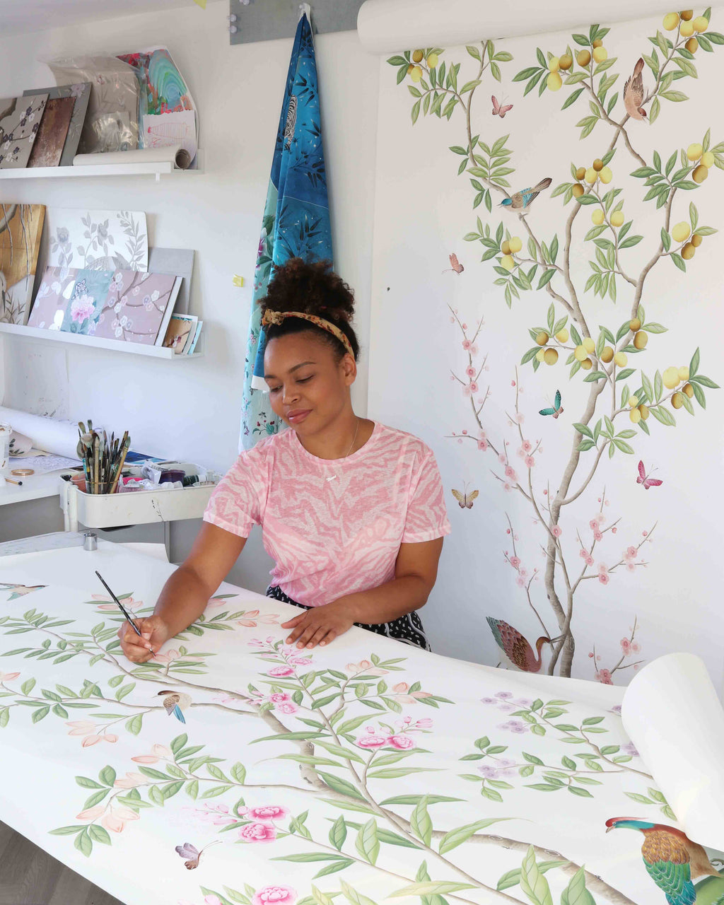 Chinoiserie artist Diane Hill working in her London Studio, creating hand painted wallpaper designs