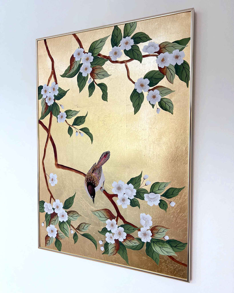 framed botanical chinoiserie painting on gold leaf paper featuring a bird on cherry blossom branch hun on wall