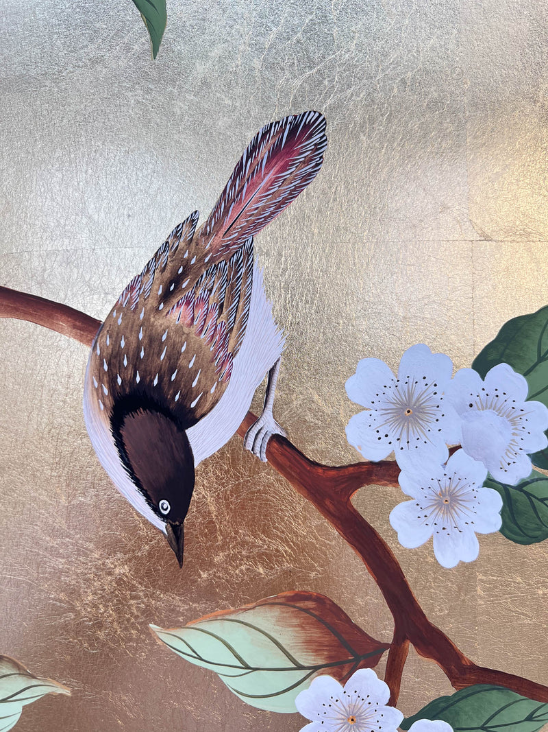 close up of botanical chinoiserie painting on gold leaf paper featuring a bird on cherry blossom branch