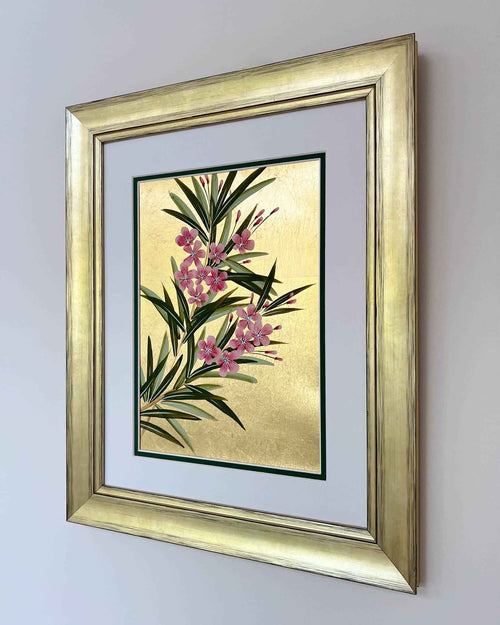 framed floral chinoiserie painting on gold leaf paper featuring pink flowers and green leaves on wall