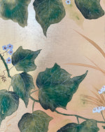 close up of botanical chinoiserie painting on gold leaf paper featuring green vines with white flowers