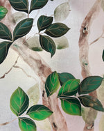 close up of botanical chinoiserie painting on metal leaf paper featuring green vines and branches