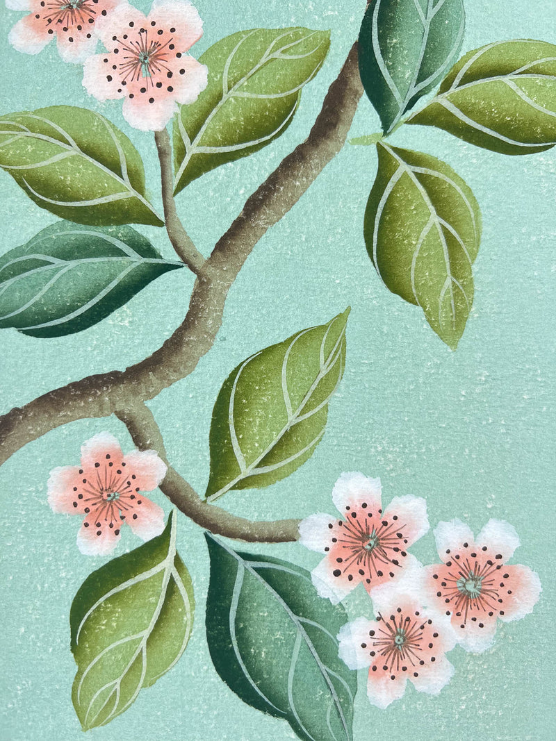 close up of framed blue chinoiserie painting on india tea paper featuring antique style blossom branch