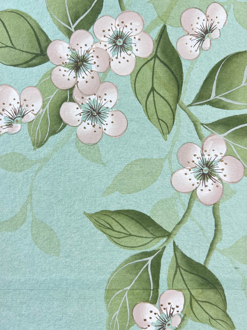 close up of blue chinoiserie painting on india tea paper featuring antique style flowers on branches