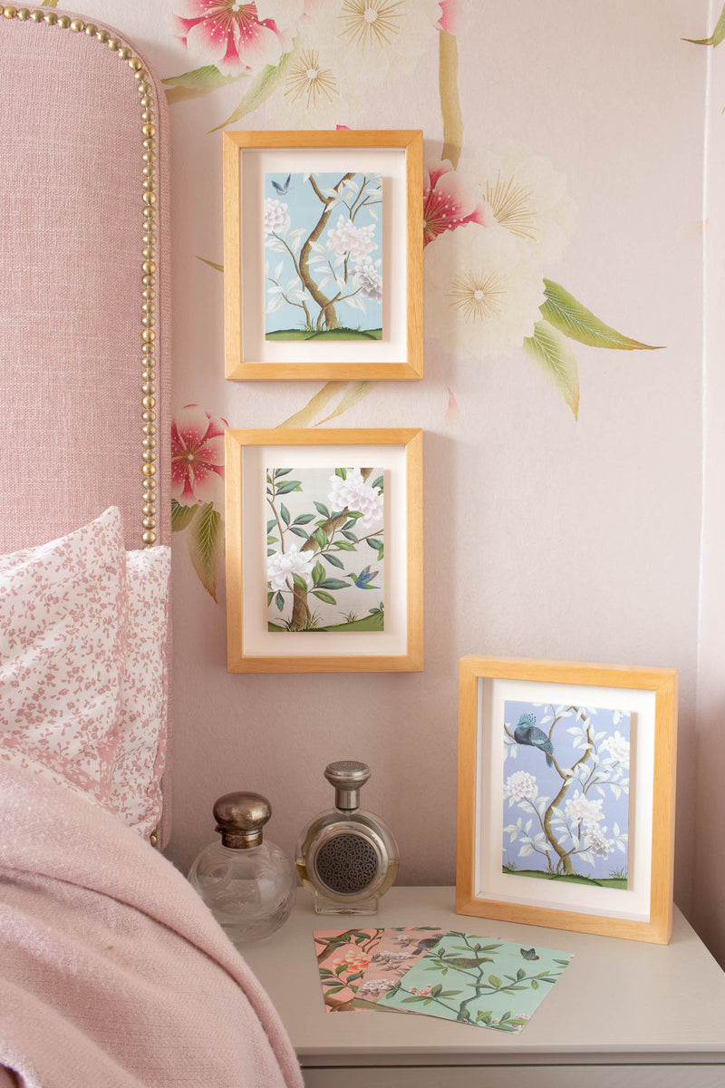 3 framed chinoiserie mini wall art prints in multi colours featuring botanical illustrations of birds, flowers, butterflies, and trees 