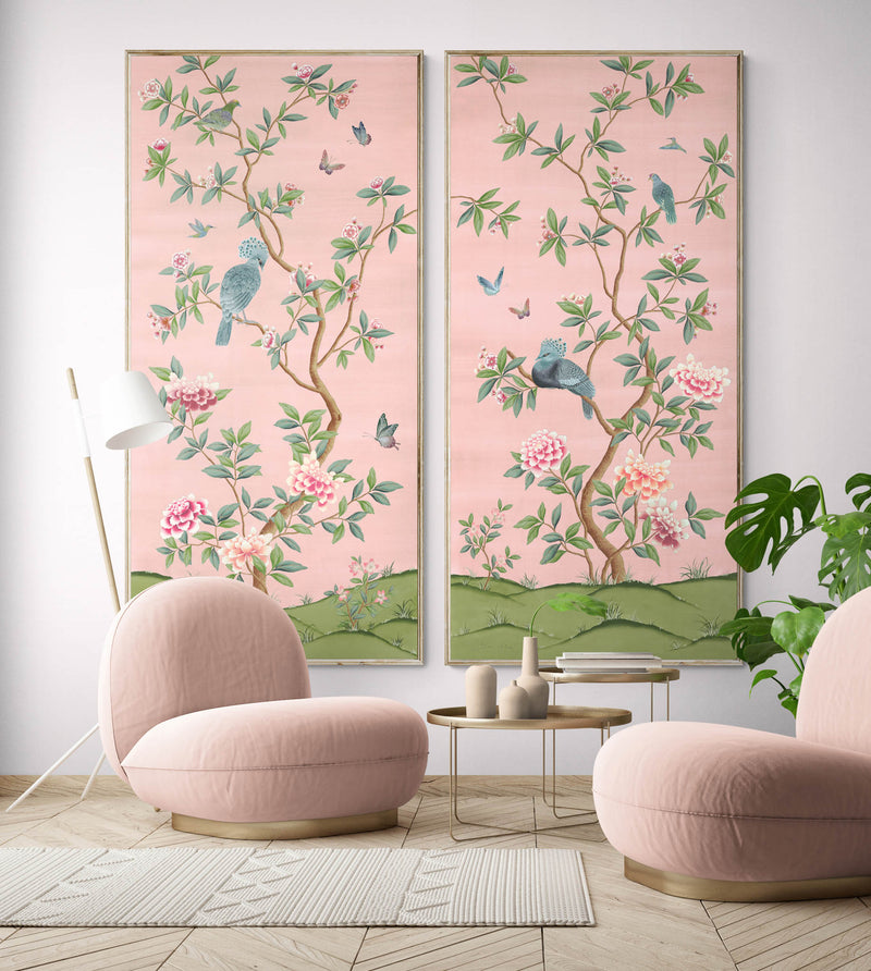pair of two framed pink and green chinoiserie wall art panel with botanical illustrations featuring birds, butterflies, and flowers hung on wall