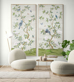 pair of two framed ivory and green botanical chinoiserie wall panel prints with flowers and birds in Chinese painting style on wall