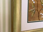 Video of framed gold chinoiserie botanical art print on bedroom wall