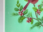 video of close up of winter-themed chinoiserie art print featuring two cardinals and butterfly on a holly branch on green snowy background on mantle