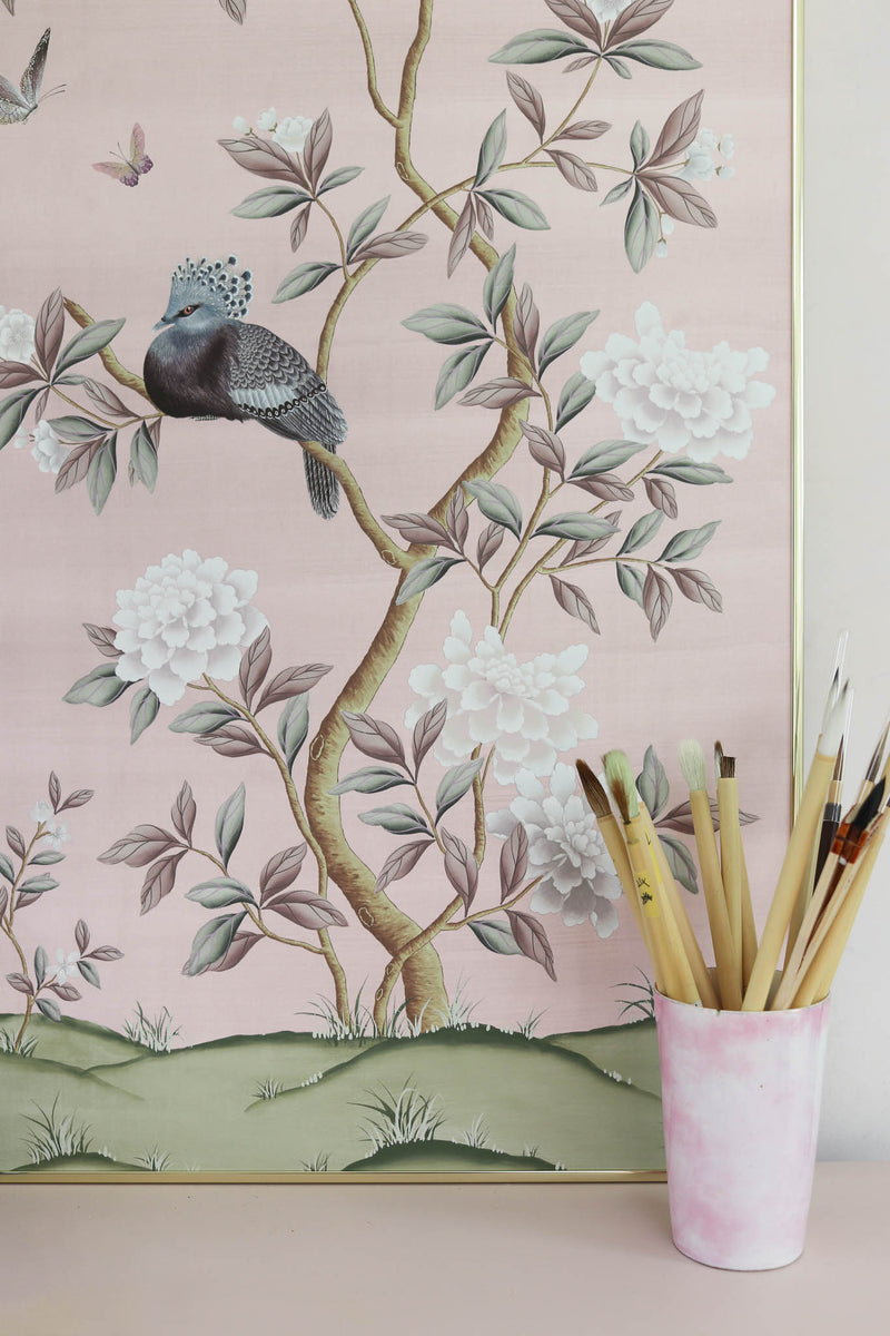 framed pink chinoiserie wall art print featuring a bird, flowers, and butterflies in Chinese painting style