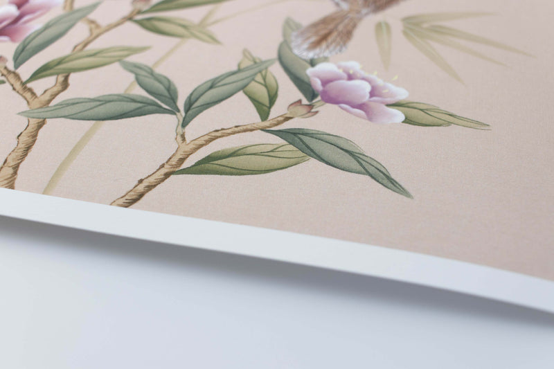 close up of blush pink chinoiserie wall art print featuring vintage style birds, butterfly and flower branches with a bamboo background