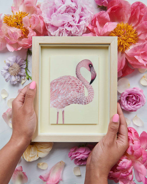 two hands holding framed botanical mini art print of pink flamingo