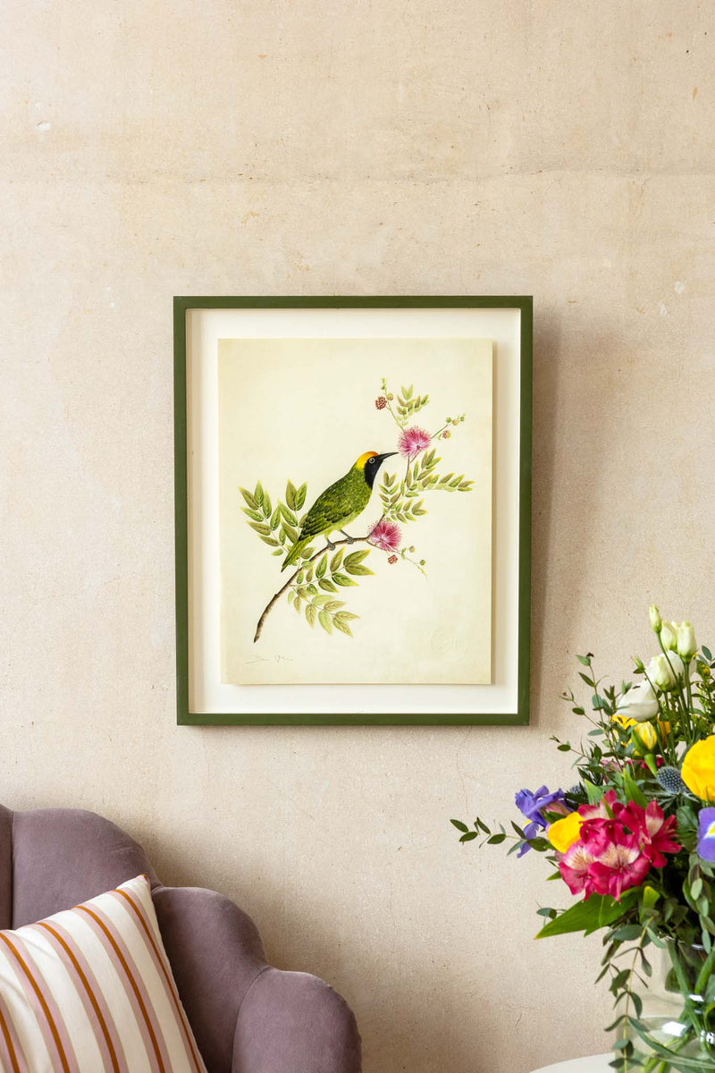 framed botanical wall art print featuring gold sparkle embellished exotic bird on tree branches with flowers hung on wall
