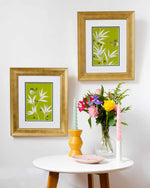 pair of two framed green and white chinoiserie wall art prints featuring bamboo a butterfly