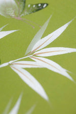 close up of green and white chinoiserie wall art print featuring bamboo a butterfly