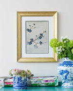 framed chinoiserie wall art print featuring Japanese-style cherry blossom branches on silver background hung on wall
