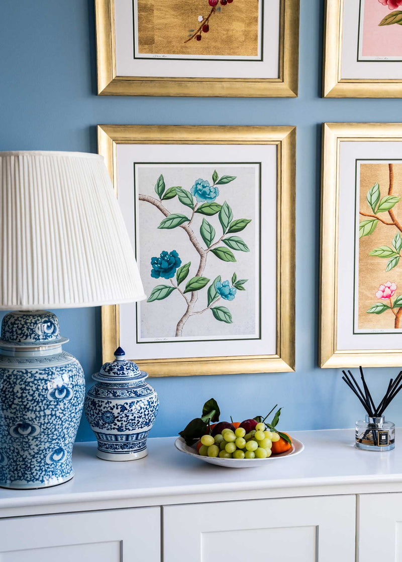 close up of set of 4 colourful framed chinoiserie wall art prints featuring vintage-style butterflies, blossoms, and flower branches displayed as gallery wall