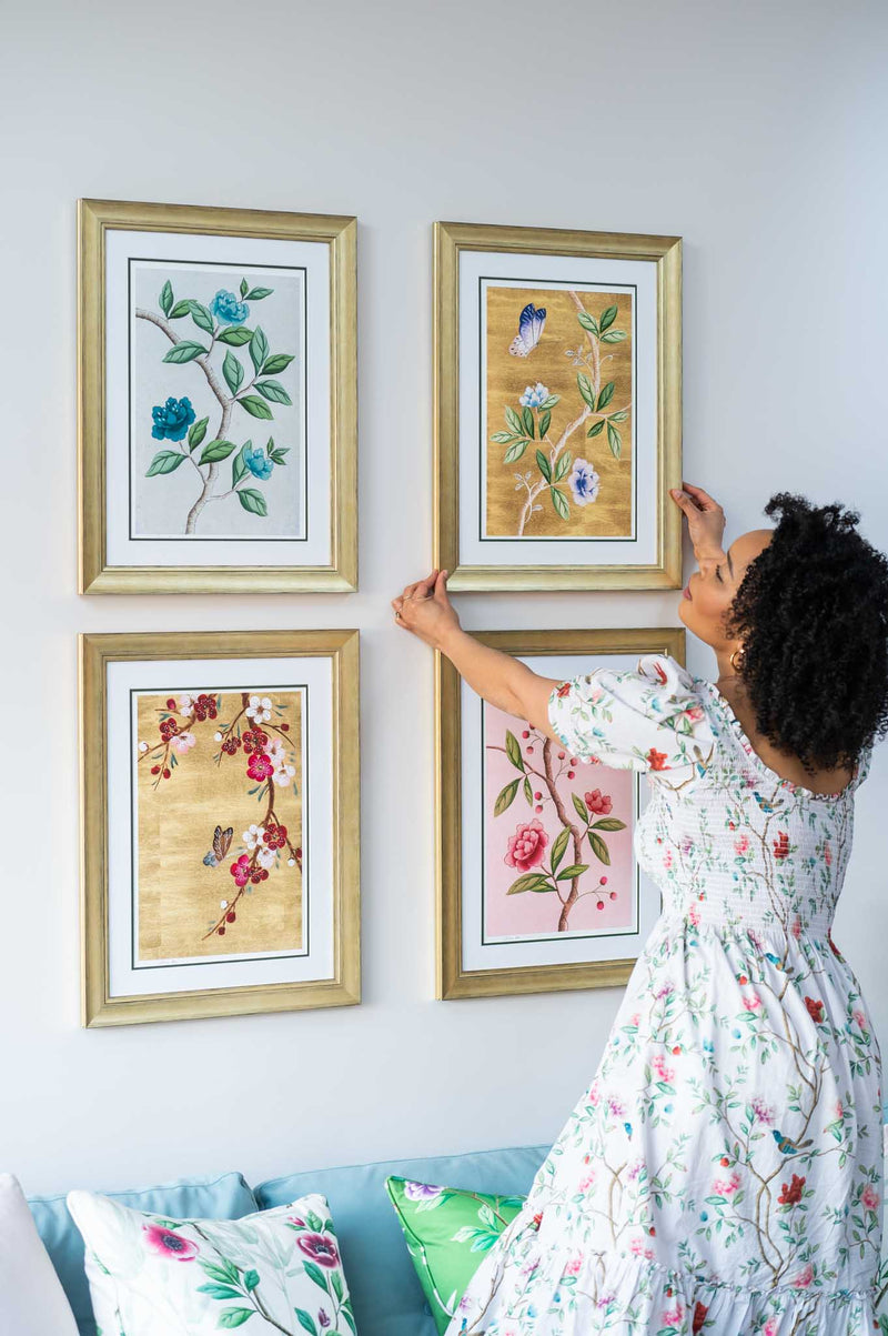 set of 4 colourful framed chinoiserie wall art prints featuring vintage-style butterflies, blossoms, and flower branches displayed as gallery wall