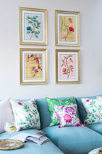 set of 4 colourful framed chinoiserie wall art prints featuring vintage-style butterflies, blossoms, and flower branches displayed as gallery wall