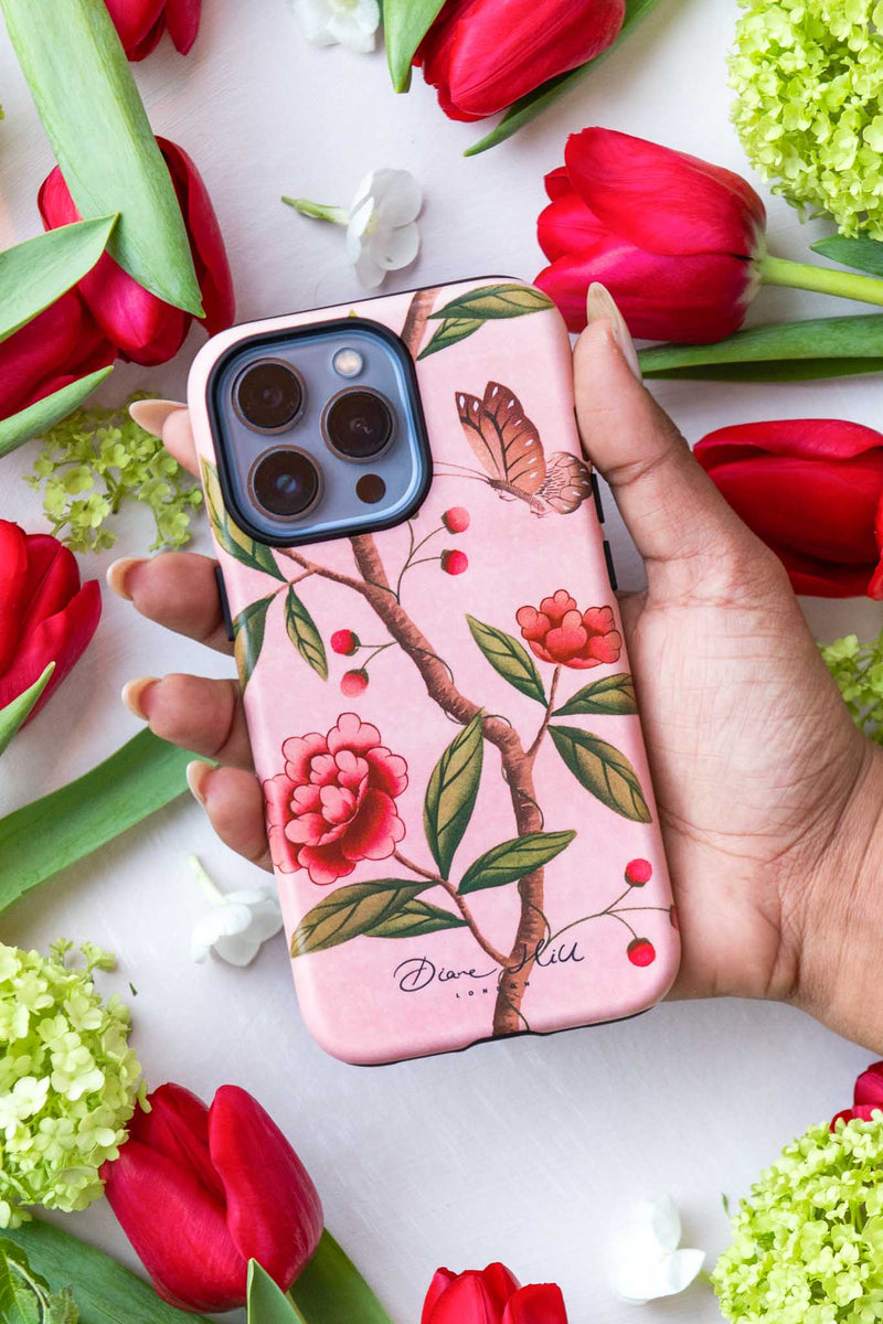 hand holding pink luxury phone case featuring vintage style butterfly and flower branch
