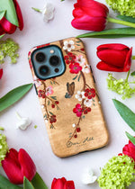 luxury chinoiserie phone case featuring a vintage inspired butterfly and cherry blossom branches on a gold background