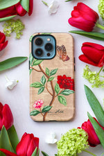 luxury chinoiserie phone case featuring vintage inspired butterfly branches and flowers on a gold background