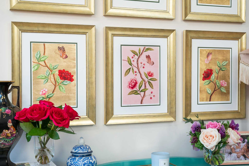 close up of set of 6 colourful framed chinoiserie wall art prints featuring vintage-style butterflies, blossoms, and flower branches displayed as gallery wall