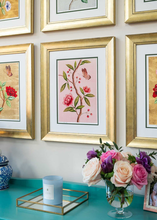 close up of set of 6 colourful framed chinoiserie wall art prints featuring vintage-style butterflies, blossoms, and flower branches displayed as gallery wall