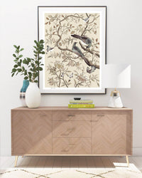 framed neutral cream modern chinoiserie wall art print featuring two birds, flowers, branches, and fruit  hung on wall
