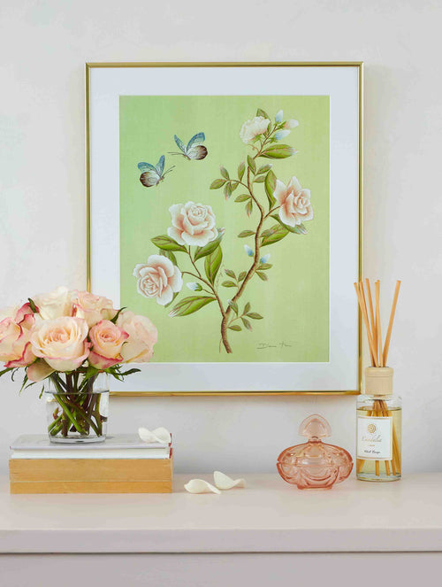 Green chinoiserie botanical style artwork with white roses two butterflies green leaves hung on wall