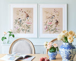 blush pink framed chinoiserie wall art prints featuring vintage style birds, butterfly and flower branches with a bamboo background hung on wall