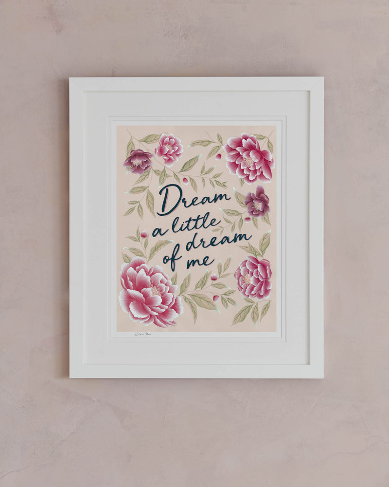framed pink vintage-style chinoiserie wall art print featuring flowers and leaves with the quote 'dream a little dream of me' hung on wall
