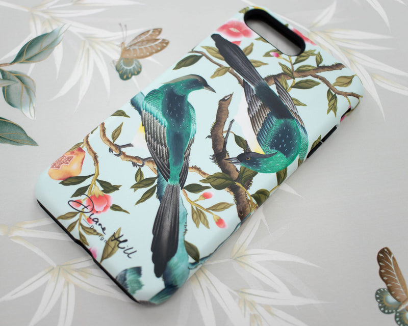 close up if blue luxury chinoiserie phone case featuring two colourful vintage inspired birds on fruit and flower branches