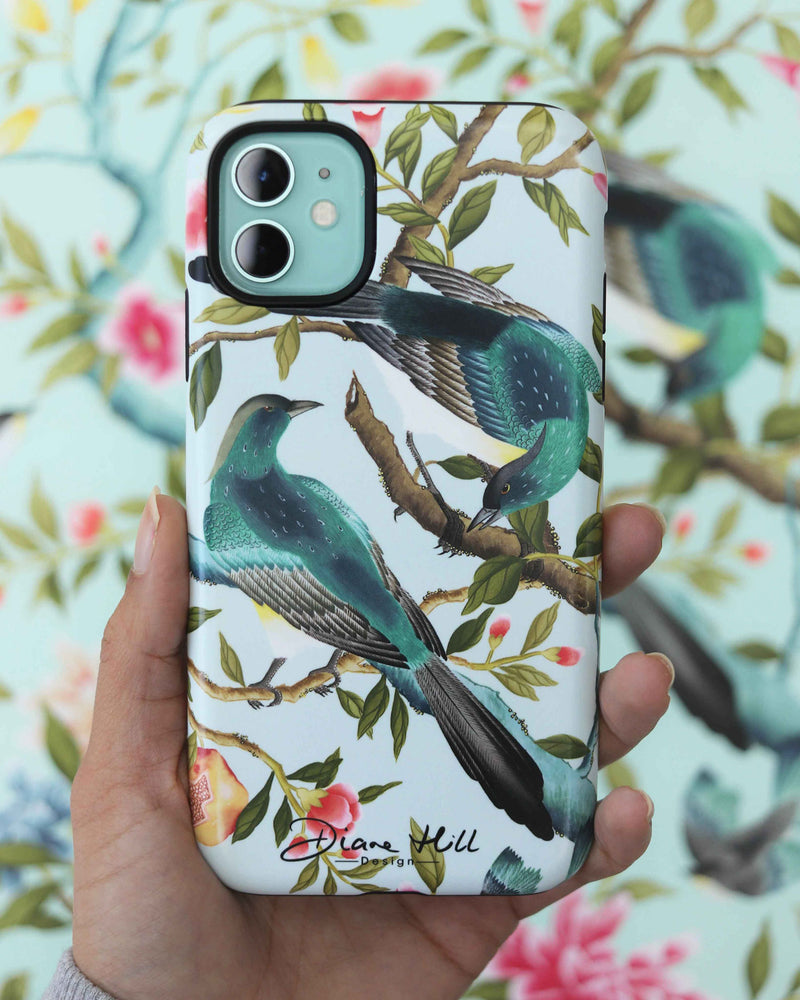 hand holding blue luxury chinoiserie phone case featuring two colourful vintage inspired birds on fruit and flower branches