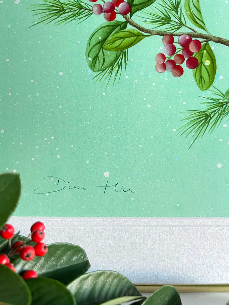 close up of winter-themed chinoiserie art print featuring two cardinals and butterfly on a holly branch on green snowy background
