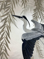 close up of framed Japanese-style chinoiserie painting featuring heron and wisteria on silver leaf background