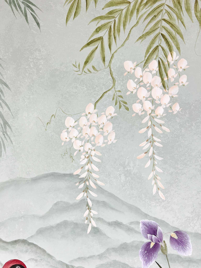 close up of Japanese style chinoiserie painting featuring crane, flowers, and hanging wisteria on blue mountain background