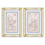 pair of soft pink framed chinoiserie wall art prints featuring butterflies, flower branches, and bamboo