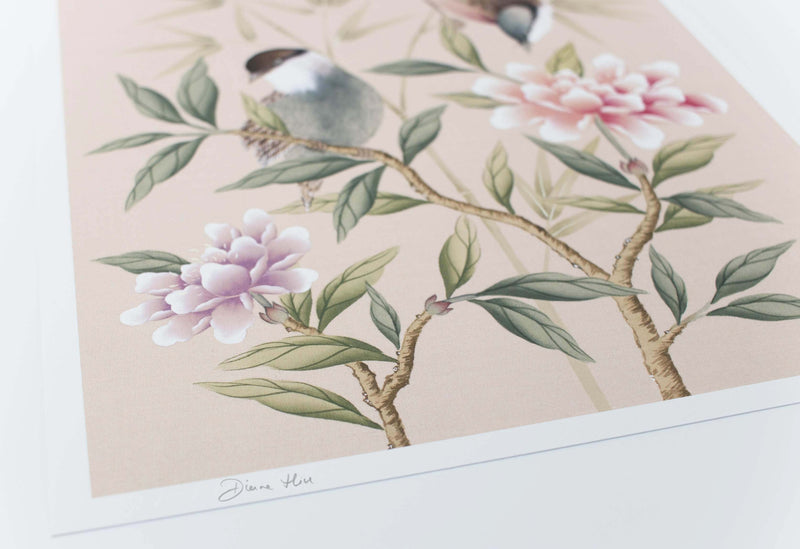 close up of blush pink chinoiserie wall art print featuring vintage style birds, butterfly and flower branches with a bamboo background