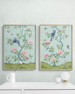 pair of 2 framed blue and green botanical chinoiserie wall art prints with flowers and birds in Chinese painting style on wall