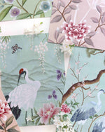close up of colourful mini chinoiserie art prints featuring botanical style birds, trees, and flowers