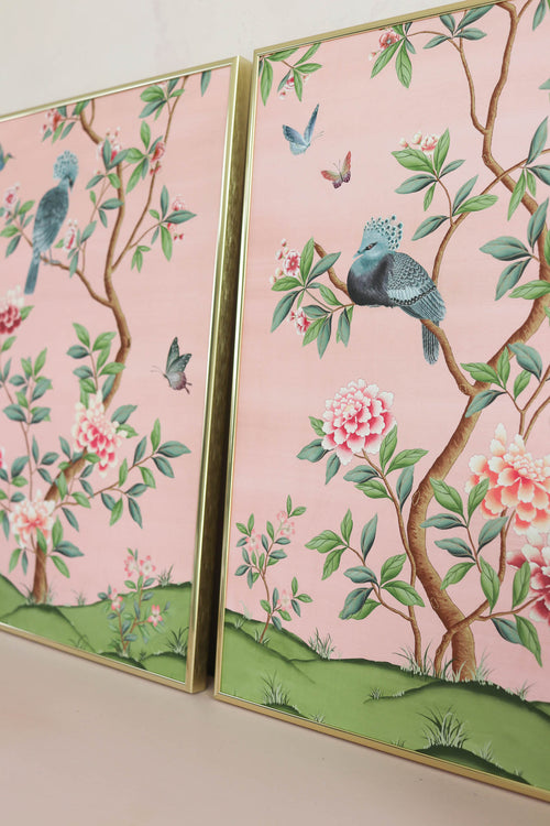 pair of 2 framed pink and green chinoiserie wall art prints with botanical illustrations featuring birds, butterflies, and flowers