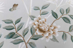 close up of pebble blue chinoiserie wall art print featuring butterflies, flower branches, and bamboo