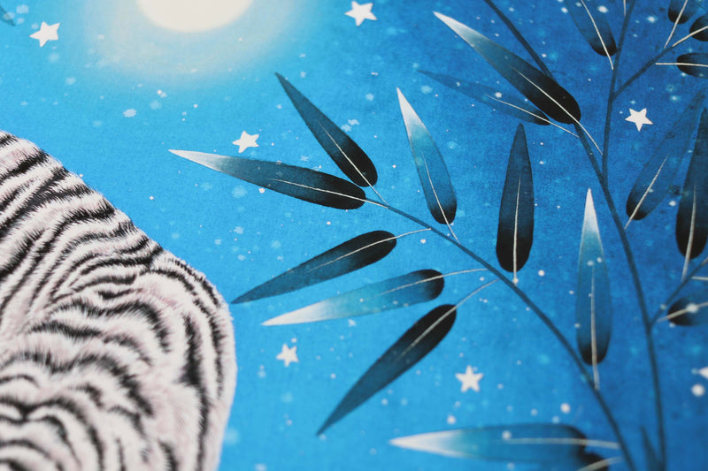 close up of blue vintage-style chinoiserie wall art print featuring a white tiger on a blue starry background