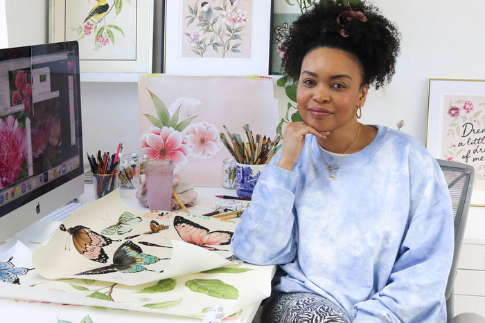 diane hill in artist studio with chinoiserie butterfly paintings and botanical wall art prints