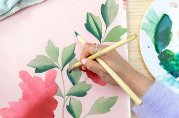 Diane holding paintbrush painting layers of shading on chinoiserie painting