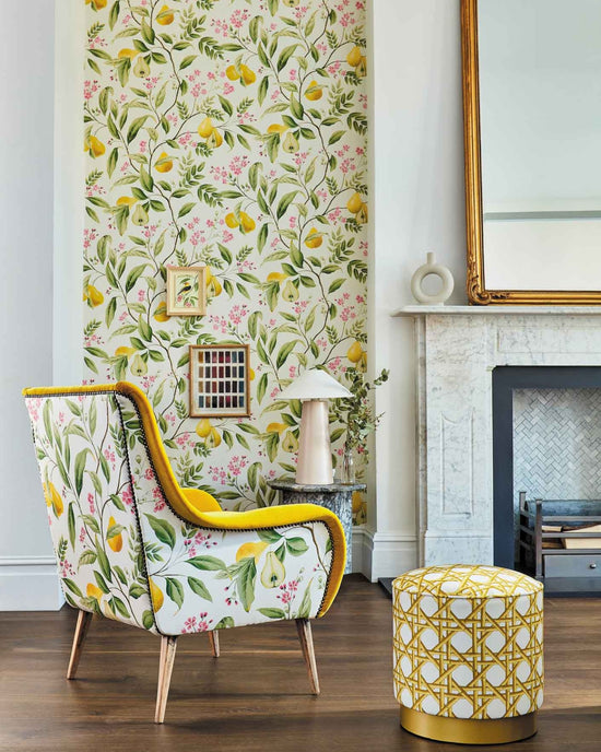 yellow botanical wallpaper featuring chinoiserie style fruits and flowers in grandmillennial style living room