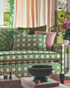 green geometric fabric featuring chinoiserie trellis design on sofa in maximalist living room