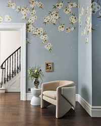 Grey chinoiserie wallpaper mural with white Japanese cherry blossom flowers in vintage style living room