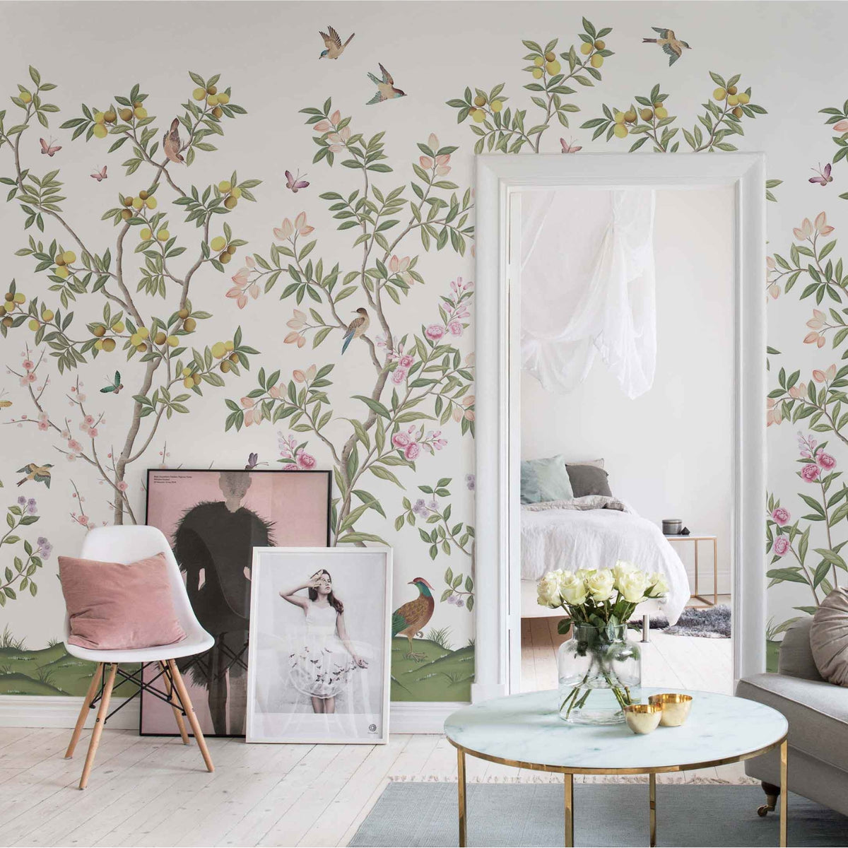 Diane Hill x Harlequin 'Chinoiserie Chic' wallpaper in a living room with sofa, mirror, coffee table, and art prints